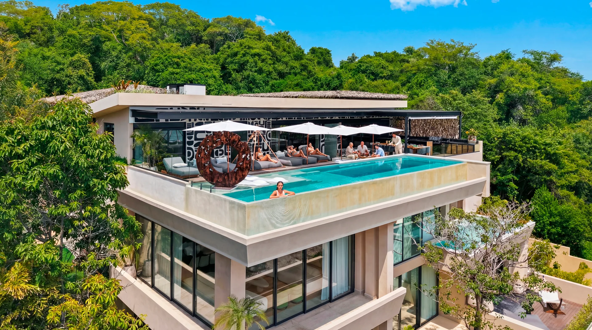 Guests enjoying The One’s rooftop infinity pool and terrace