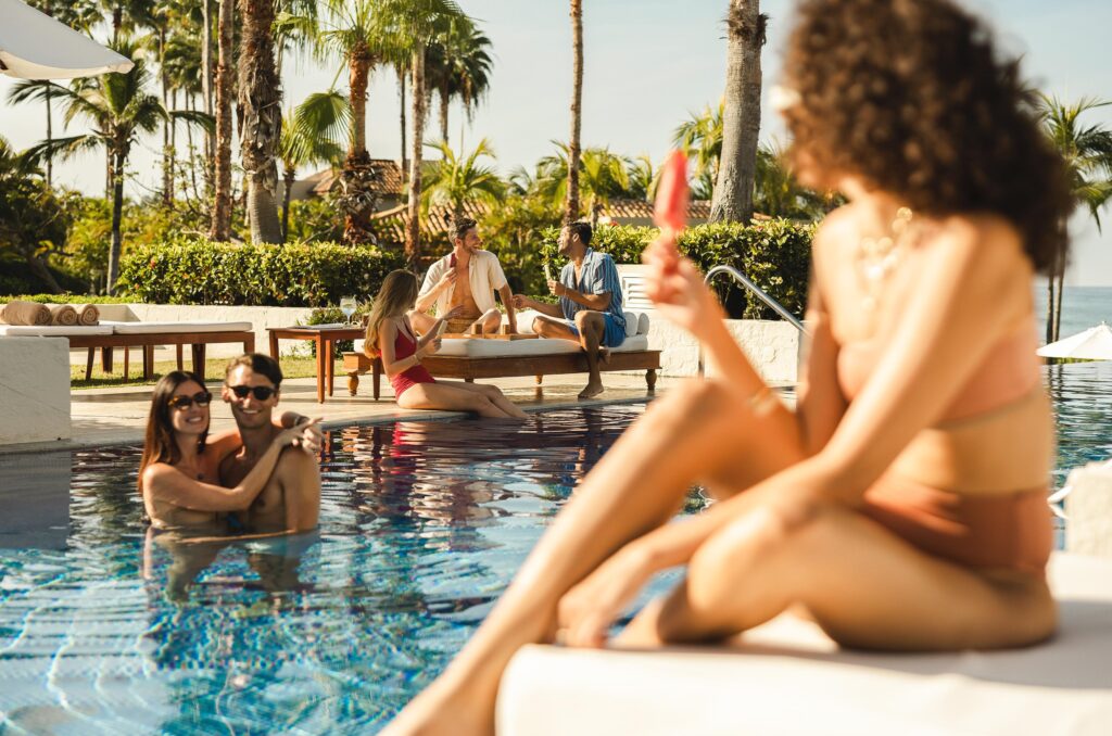 People enjoying in pool side area