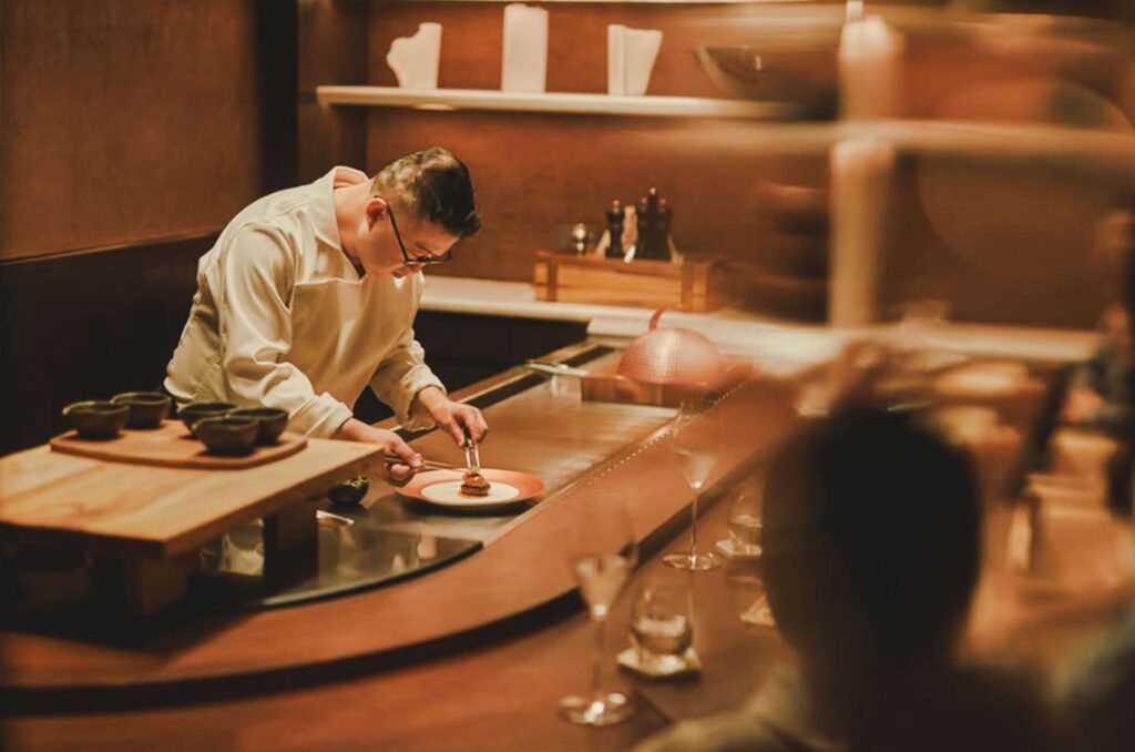 A chief is making the dish