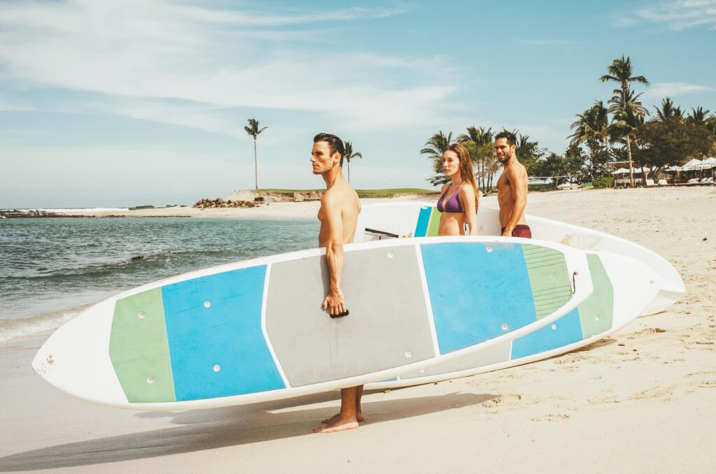 three people going for surfing