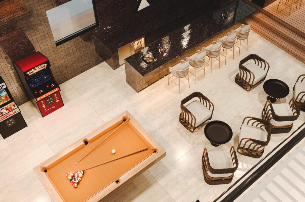 Luxury gaming area with snooker table and gaming machines in it